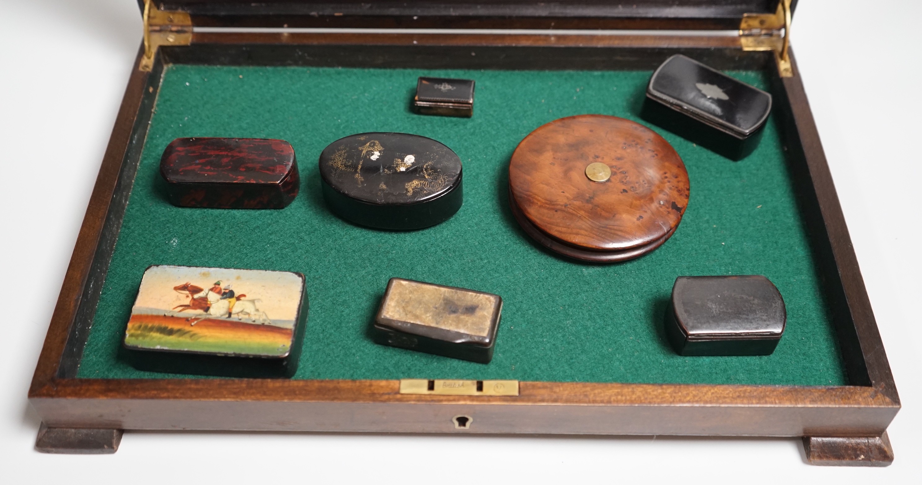 A collection of turned treen and various japanned papier mache boxes, contained in a glazed topped mahogany box-37cms x 24cms